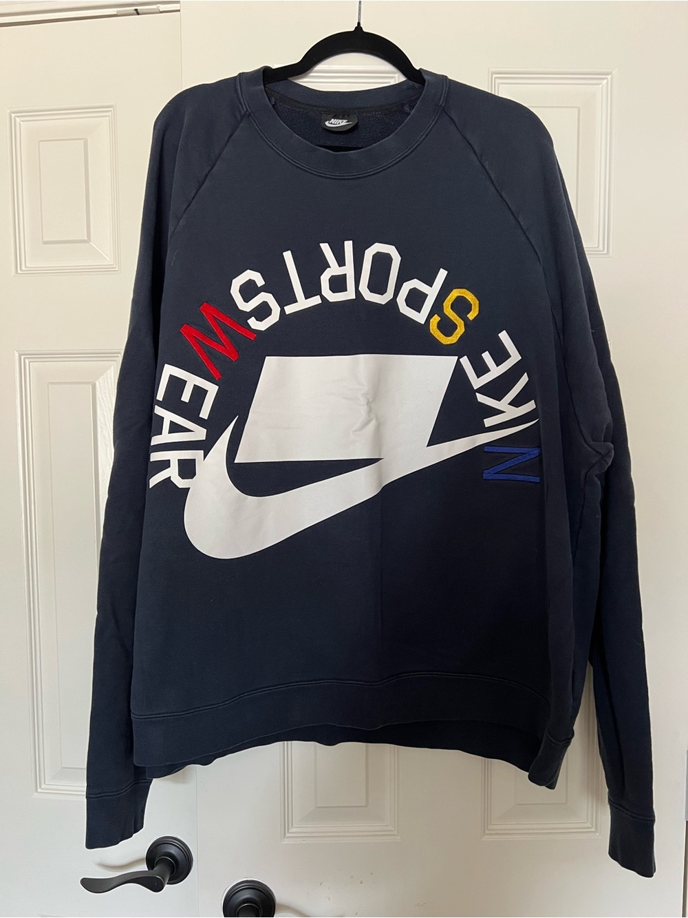 Nike Black Crewneck Sweatshirt with White Swoosh and Multicolor Sportswear Text